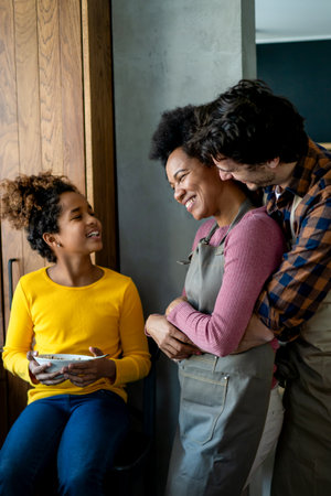 Happy multiethnic family in love together in kitchen. Parents child together conceptの写真素材