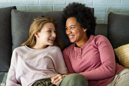 Loving african american foster care parent single mother embrace teen daughterの写真素材