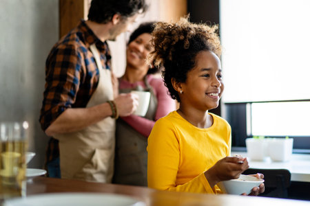 Happy multiethnic family in love together in kitchen. Parents child together conceptの写真素材