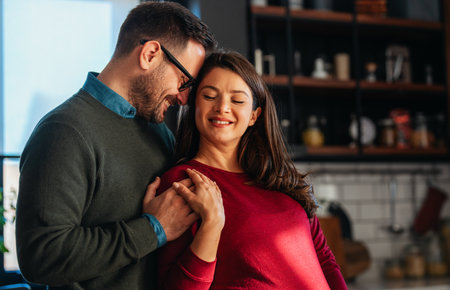 Man in love hugs his pregnant wife, they are waiting together for the babys arrival. Love, familyの写真素材
