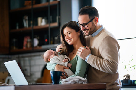 Parents with baby having video call online, conversation with relatives, communicating with friendsの写真素材