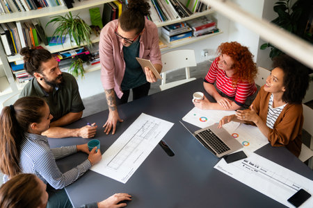 Diverse employees gathered in the office having fun during brainstorming while discussing new ideasの写真素材
