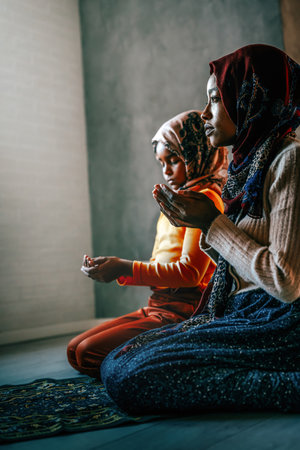 Portrait of muslim mother with child during islamic religious cultural activitiesの写真素材