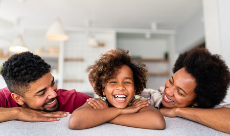 Portrait of smiling young african american family with small teenage daughter. Happy familyの写真素材