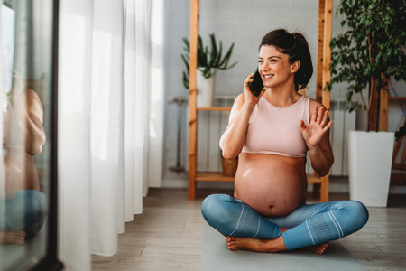 Live streaming, fitness and phone of pregnant woman exercise, pilates or workout on social mediaの写真素材