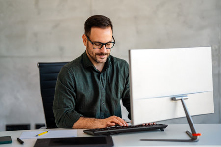 Success young professional businessman investor,manager at workplace working on computer in officeの写真素材
