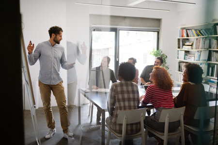 Diverse employees gathered in the office having fun during brainstorming while discussing new ideasの写真素材