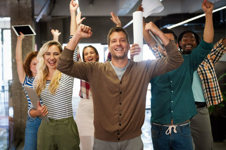 Happy diverse employees team celebrating success, business achievementの写真素材