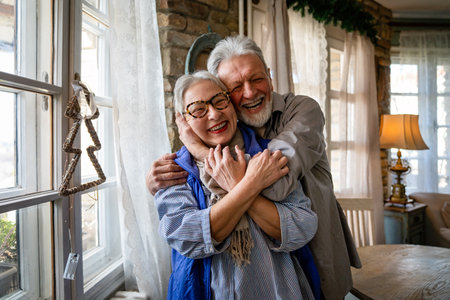 Happy senior adult mature pensioner couple hugging, bonding, thinking of good futureの写真素材
