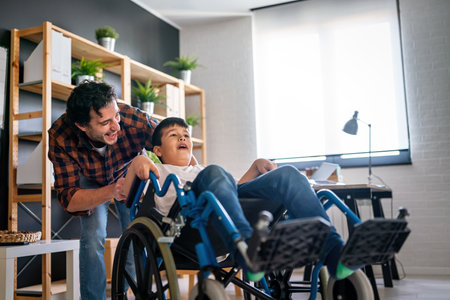 Single parent with asian child with disability in wheelchairの写真素材