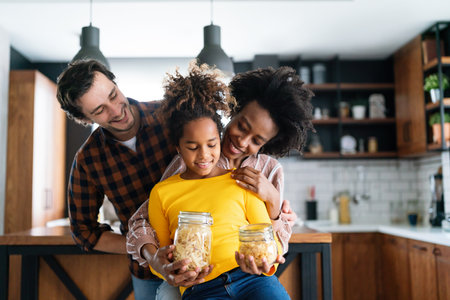 Happy multiethnic family in love together in kitchen. Parents child together conceptの写真素材