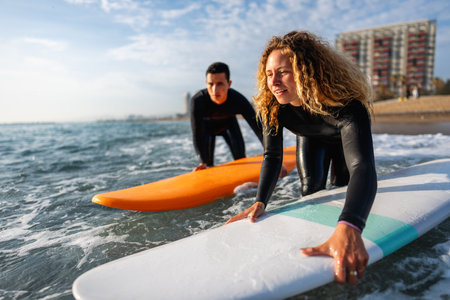 Two friends surfers going for surfing in the sea. Carrying surfboards running in to the sea surfing