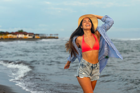 Smiling woman on a tropical beach, enjoying her summer vacation. Travel people happiness conceptの写真素材