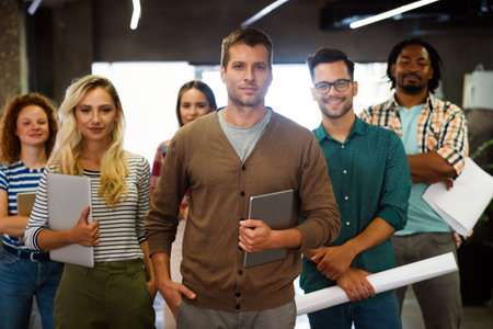 Portrait of successful creative business team looking at camera, smiling. Startup success concept.の写真素材