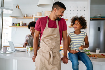 Happy african american single dad spends happy moments with his daughter. Family love conceptの写真素材
