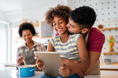 Happy african american preeteen girl using digital tablet for education, fun at home. Family conceptの写真素材