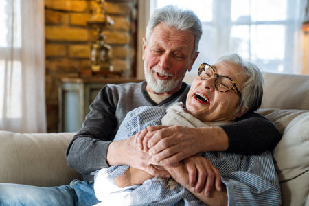 Happy senior adult mature pensioner couple hugging, bonding, thinking of good futureの写真素材