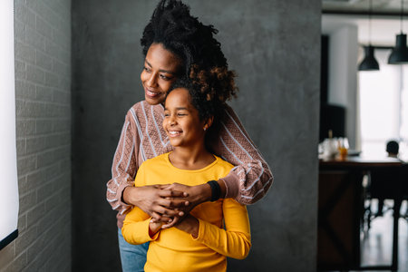 Family portrait. Loving mother and daughter at home hugging. Love, people, happiness concept.の写真素材