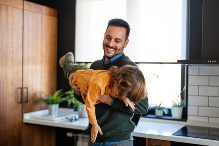 Portrait of father and son having fun at home, family life, parenting, love and bonding conceptsの写真素材