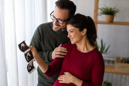 Man in love hugs his pregnant wife, they are waiting together for the babys arrival. Love, familyの写真素材