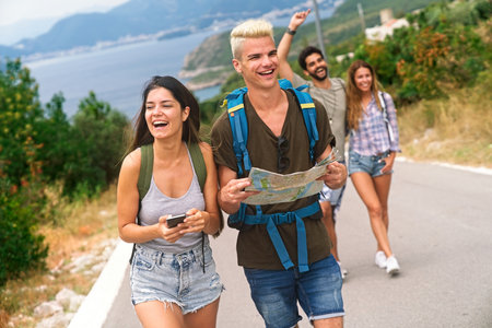 Multiracial best friends having fun outside. Happy friends on road trip have fun at summer vacationの写真素材