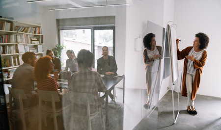 Multiracial business coworkers have fun cooperating together at office meeting. Teamwork conceptの写真素材