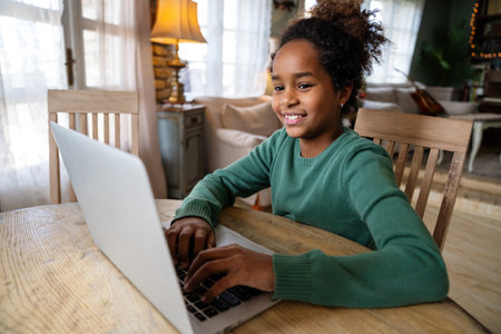African girl student watching video course, distance e-learning, studying with online teacherの写真素材