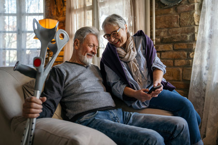 Happy bonding older married couple relaxing, laughing, enjoying leisure time together at home.の写真素材