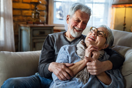Happy senior adult mature pensioner couple hugging, bonding, thinking of good futureの写真素材