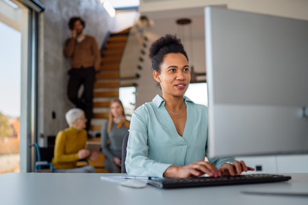 Portrait of african american female IT developer, programmer, designer working with programming codeの写真素材