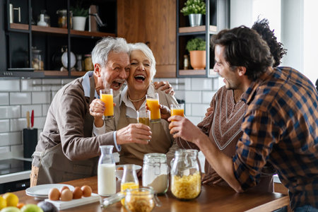 Multi generation multiethnic family having fun, talking around a kitchen table.の写真素材