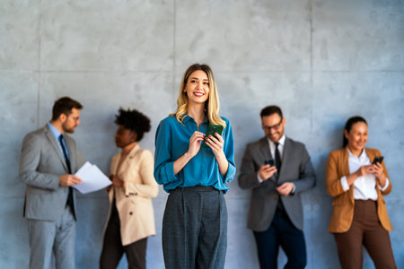 Group of young business people working as a team and communicating in corporate officeの写真素材