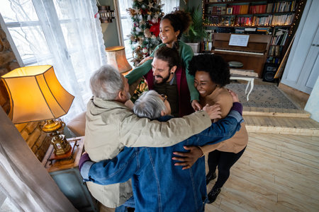 Happy multiethnic multi-generational family enjoying Christmas time together. People love concept.の写真素材