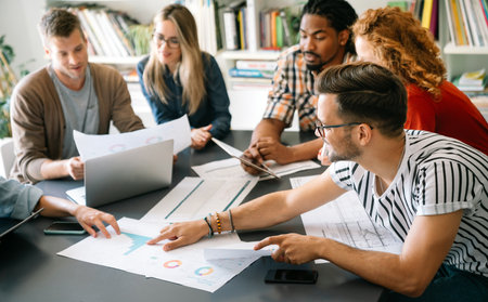 Successful multiethnic group of designers, architects, business people at work in officeの写真素材