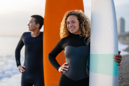 Young people having fun, enjoying their vacations outdoors at the beach with surfboards. Sport, surfの写真素材