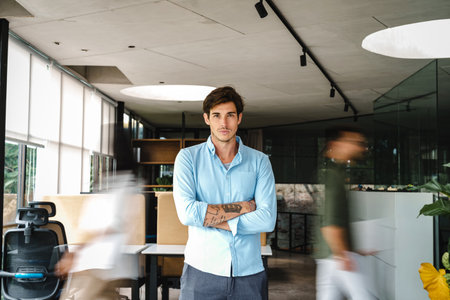 Success man with diverse employees walking in background, business coworking spaceの写真素材
