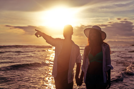 Vacation couple walking on beach together in love. Travel honeymoon people happiness conceptの写真素材