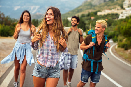 Friendship, travel, vacation, summer and people concept. Group of smiling friends with map travelingの写真素材