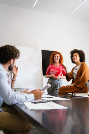 Young businesswoman leading a discussion during a meeting with her colleagues.の写真素材