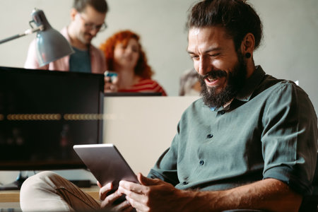 Portrait of happy success man working in a busy modern workplace, Startup coworker conceptの写真素材