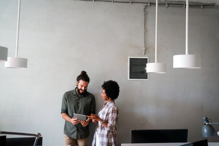 Group of business people and software developers working as a team in modern startup officeの写真素材