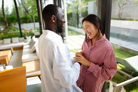 Interracial couple embracing celebrating love, diversity, and unity in a supportive relationshipの写真素材