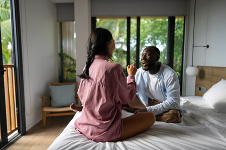 Interracial couple enjoying a joyful and intimate moment, embracing love, laughter, and togethernessの写真素材