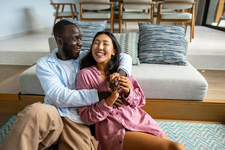 Joyful African-Asian couple embracing their diverse backgrounds, celebrating togetherness, identityの写真素材