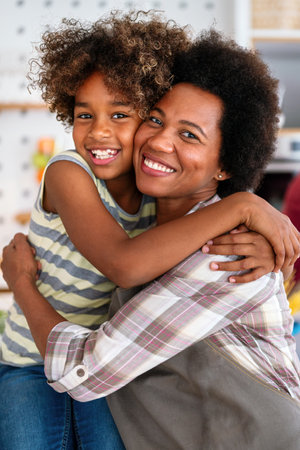 African american woman hugging her smiling teen daughter. Family love single parent child conceptの写真素材