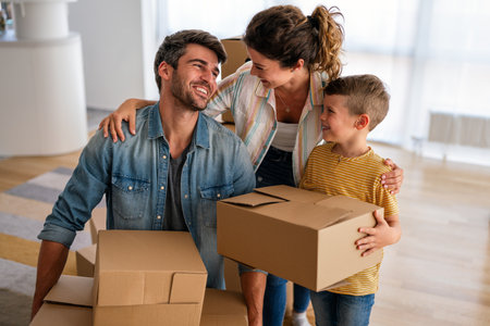 Happy family with child moving with boxes in a new apartment house.の写真素材