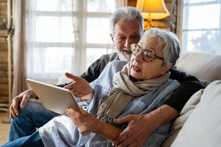 Mature woman having problem with computer tablet, irritated by bad news, electronic deviceの写真素材