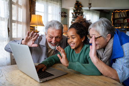 Portrait of a happy multigeneration family using electronic devices at home togetherの写真素材