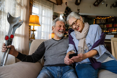 Happy bonding older married couple relaxing, laughing, enjoying leisure time together at home.の写真素材
