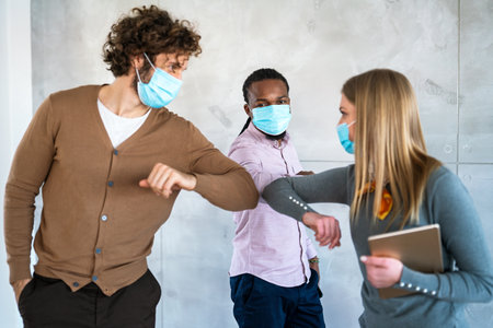 Coworking office and social distance during pandemic virus. Business people in protective masksの写真素材